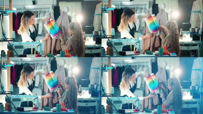 一个女裁缝和一个女孩正在裁缝中研究颜色