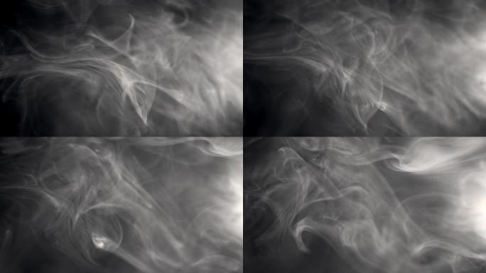 白烟的慢动作镜头漂浮在黑色背景上的空中。雾，火烟，蒸气在黑暗中缓慢移动
