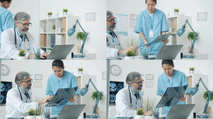 医生使用笔记本电脑，然后与在现代医院办公室工作的护士讨论MRI扫描