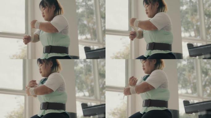 适应性亚洲女运动员准备在健身房锻炼