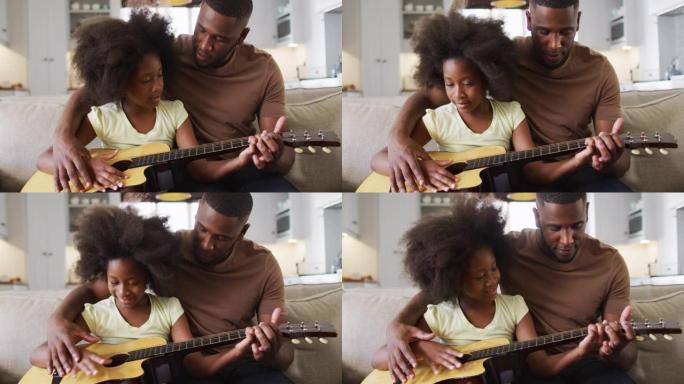 African american father and his daughter sitting o