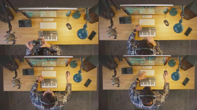 相机在工作站上放大男性音乐家的俯视图，键盘和麦克风在夜间在演播室戴上耳机-慢动作拍摄
