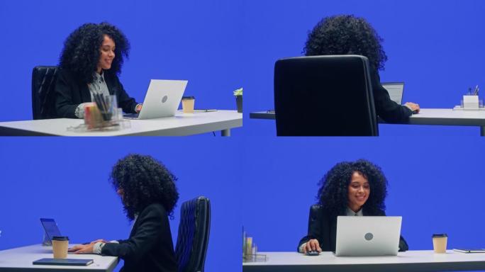 绿屏办公室背景: 坐在办公桌前的黑人女商人在笔记本电脑上工作。从事大数据电子商务工作的非裔美国女性。