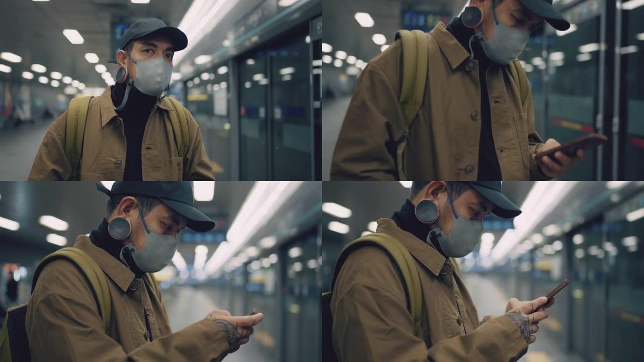 该男子的特写镜头正在等待地铁列车时站着并使用手机。