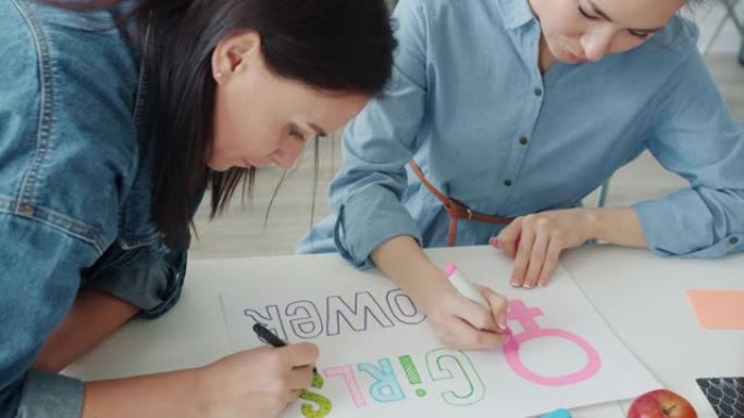 慢动作的亚洲和高加索妇女绘制女孩力量旗帜和交谈