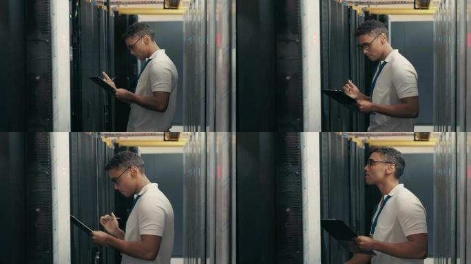 一个英俊的年轻技术人员在服务器机房进行维护检查时使用剪贴板的4k视频片段