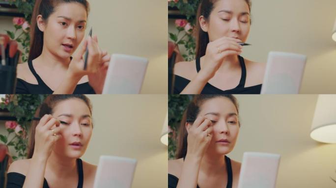 特写: 亚洲女性化妆影响者使用眼线录制化妆技巧教程病毒内容