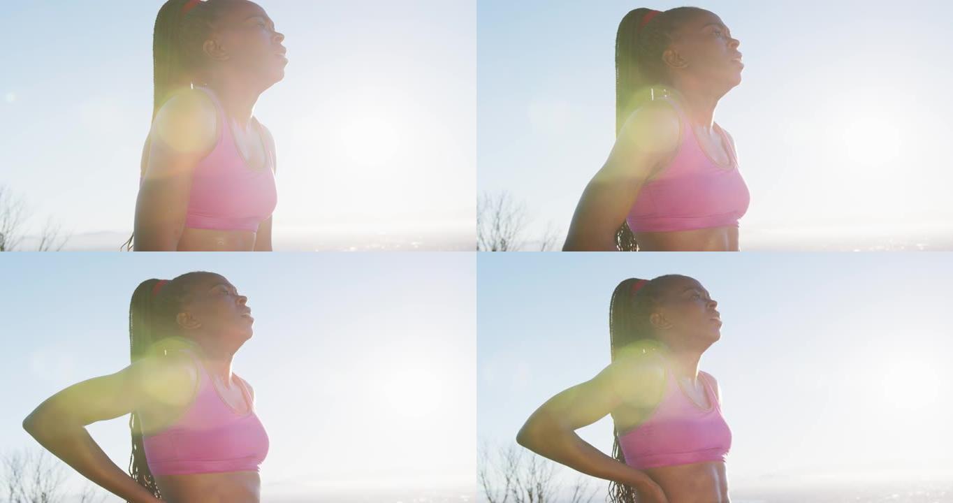 非裔美国妇女在户外锻炼，日落时在乡村休息