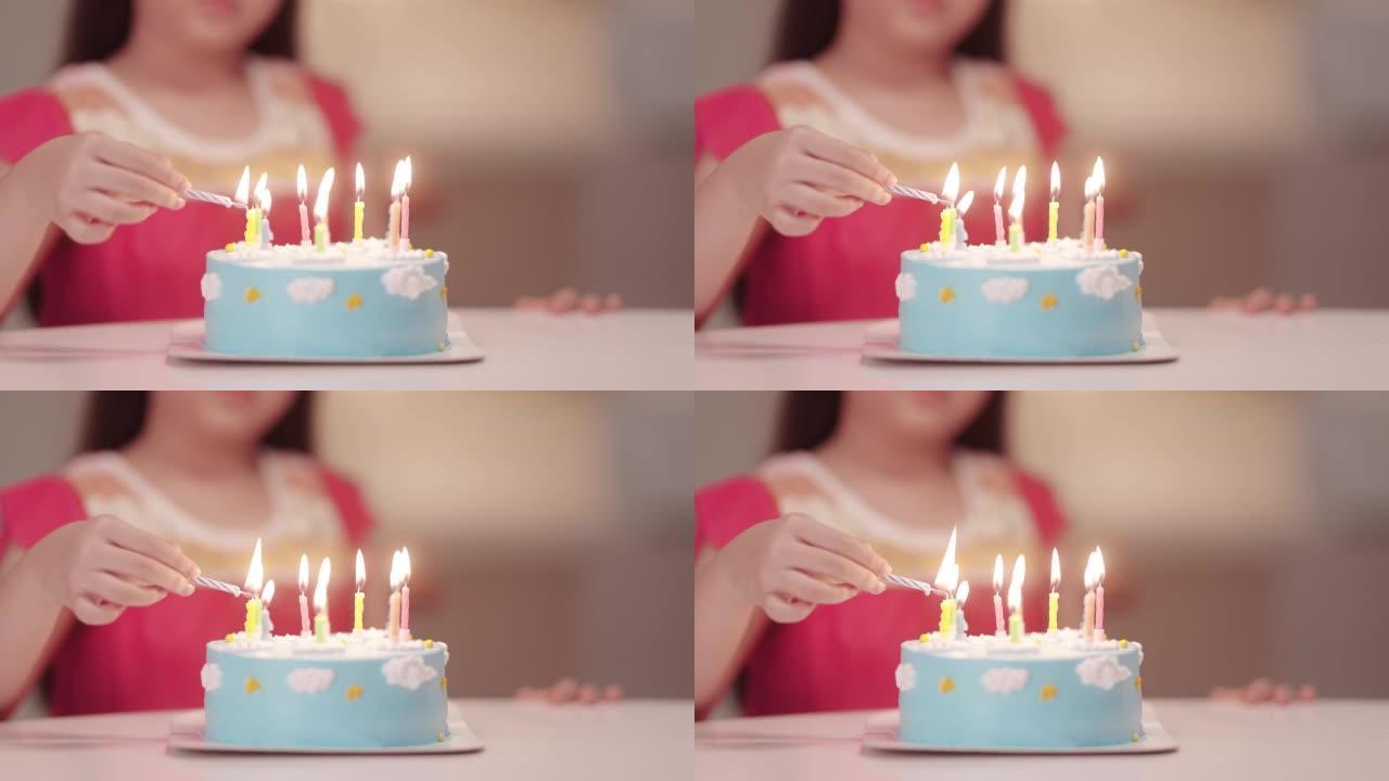 快乐的亚洲女孩在她的生日蛋糕上吹蜡烛
