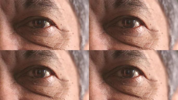 一名正在验光师寻求改善视力的老年男子的光学视力检查特写。棕色眼睛和深色皮肤闪烁凝视的高级成熟男性的面