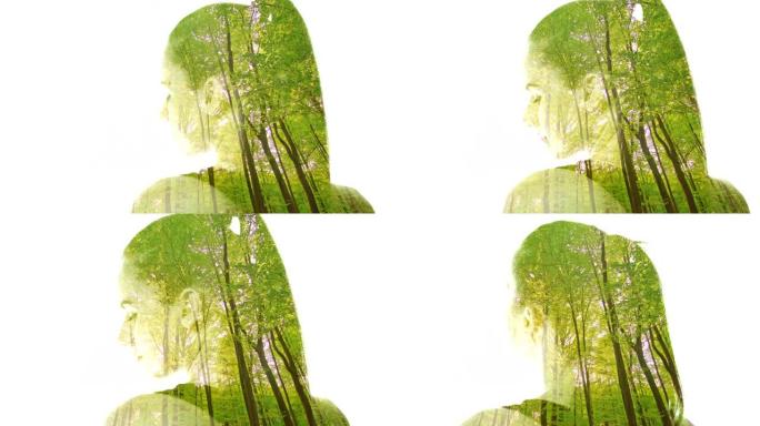 一名年轻女子的双重曝光叠加在绿色森林上