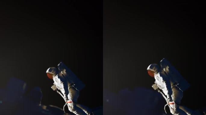 穿着白色宇航服的宇航员与太空飞船一起工作。外层空间限制