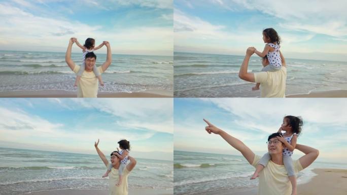 亚洲可爱的女儿白天在海滩上散步时坐在父亲的肩膀上