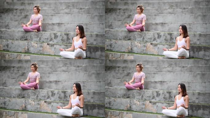 2亚洲华人女性朋友在公园锻炼早晨瑜伽冥想