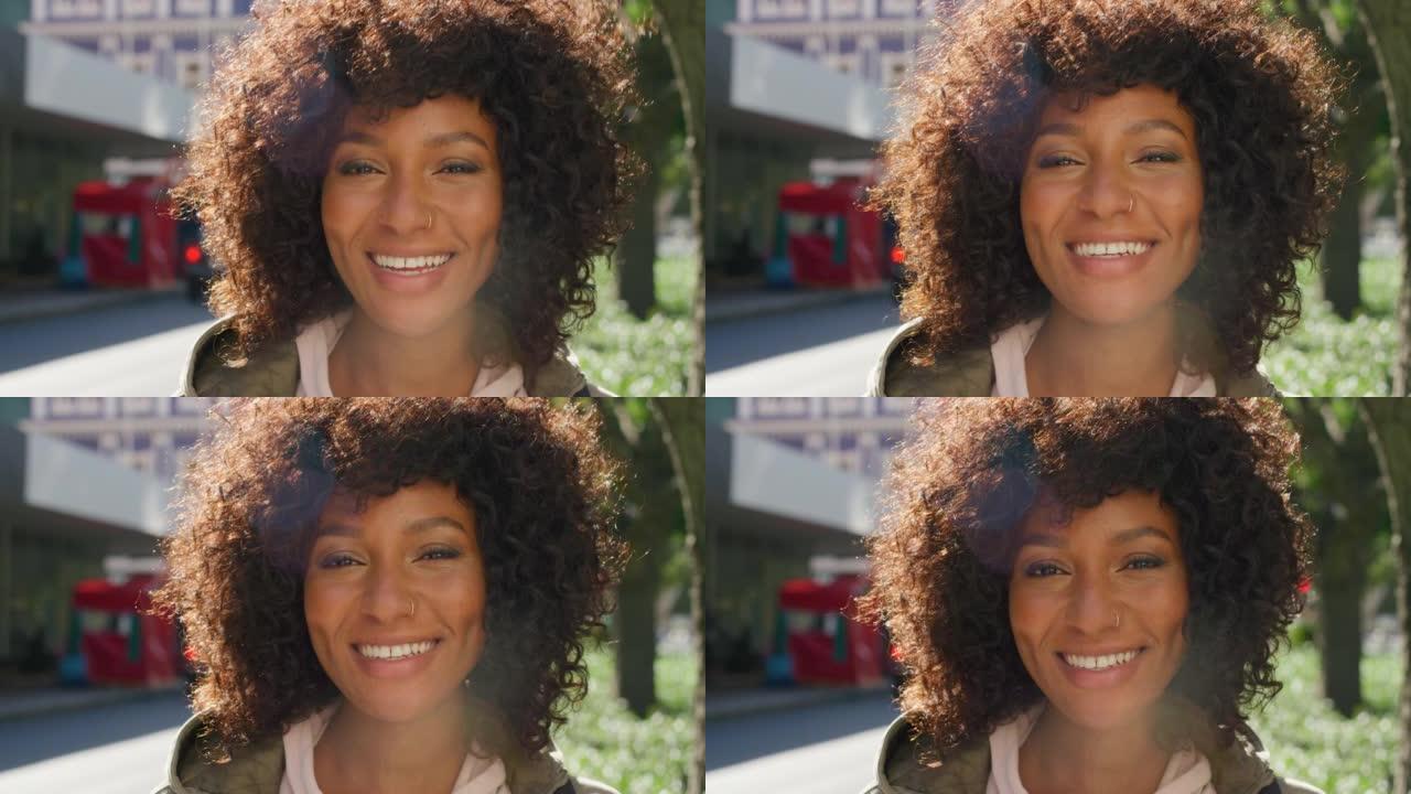 一个美丽而自信的黑人女性的脸，一个卷曲的非洲裔在镇上看起来很快乐。一个年轻美丽的女人在城市里微笑着看