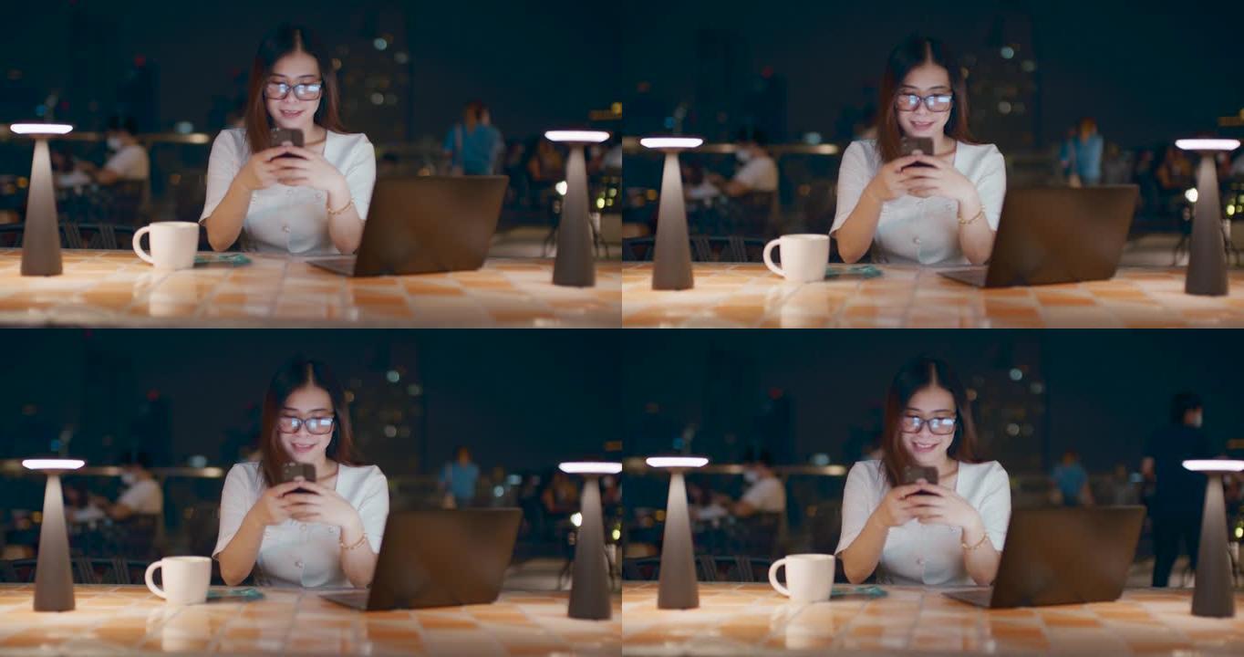 女人在城市户外晚上使用笔记本电脑