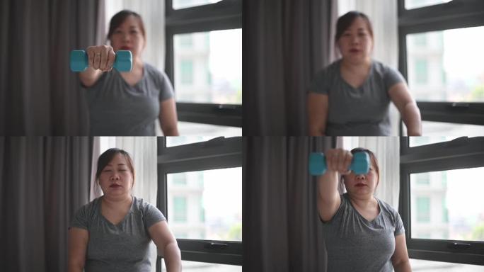 周末在家用哑铃在线锻炼课进行亚洲中国女性身体积极锻炼