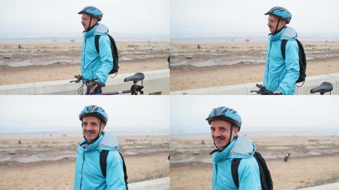 在海岸骑自行车的高级男子