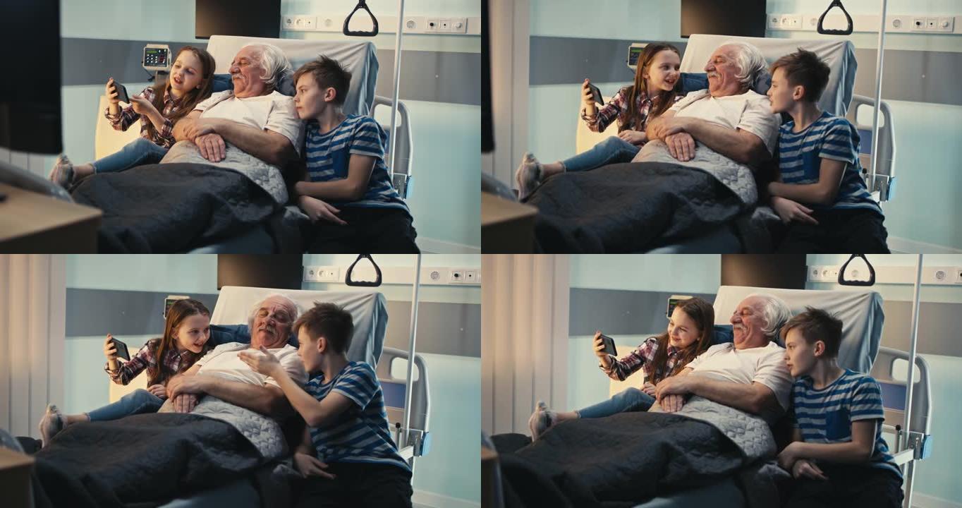 高级患者在医院病房与孙子讨论智能手机上的视频
