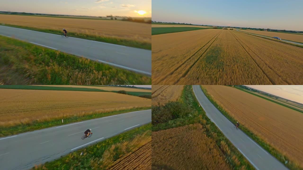 空中运动员骑着自行车穿越日落的乡村
