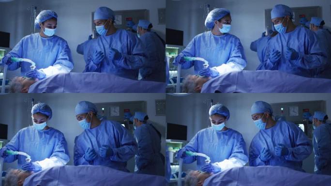 混血外科医生穿着防护服看着手术室的病人