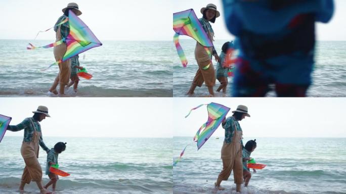 母亲和儿子在沙滩上放风筝奔跑