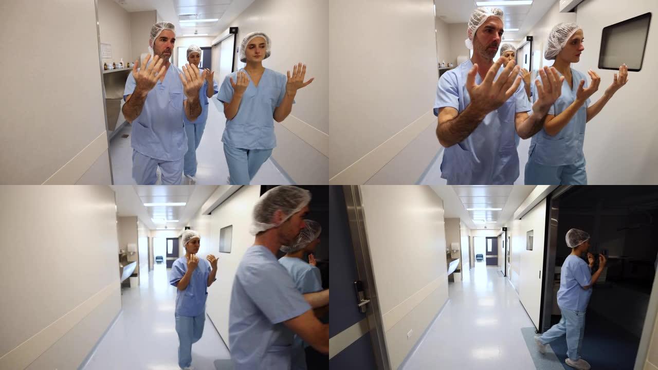 医生和护士团队在擦洗后走进手术室
