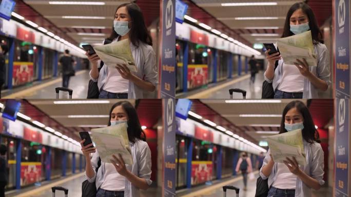 亚洲旅游在地铁站看手机