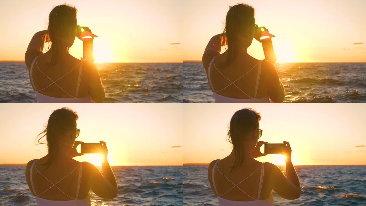 特写: 女性旅行者拍摄亚得里亚海背后的日落照片。