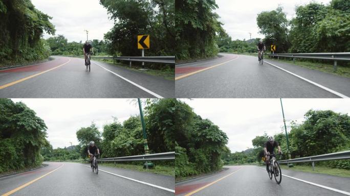 亚洲青年男子骑自行车公路旅行