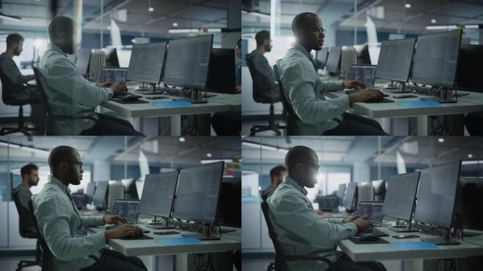 正宗办公室: 在台式电脑上工作的专业黑色IT程序员。男性网站开发人员和软件工程师开发应用程序，视频游
