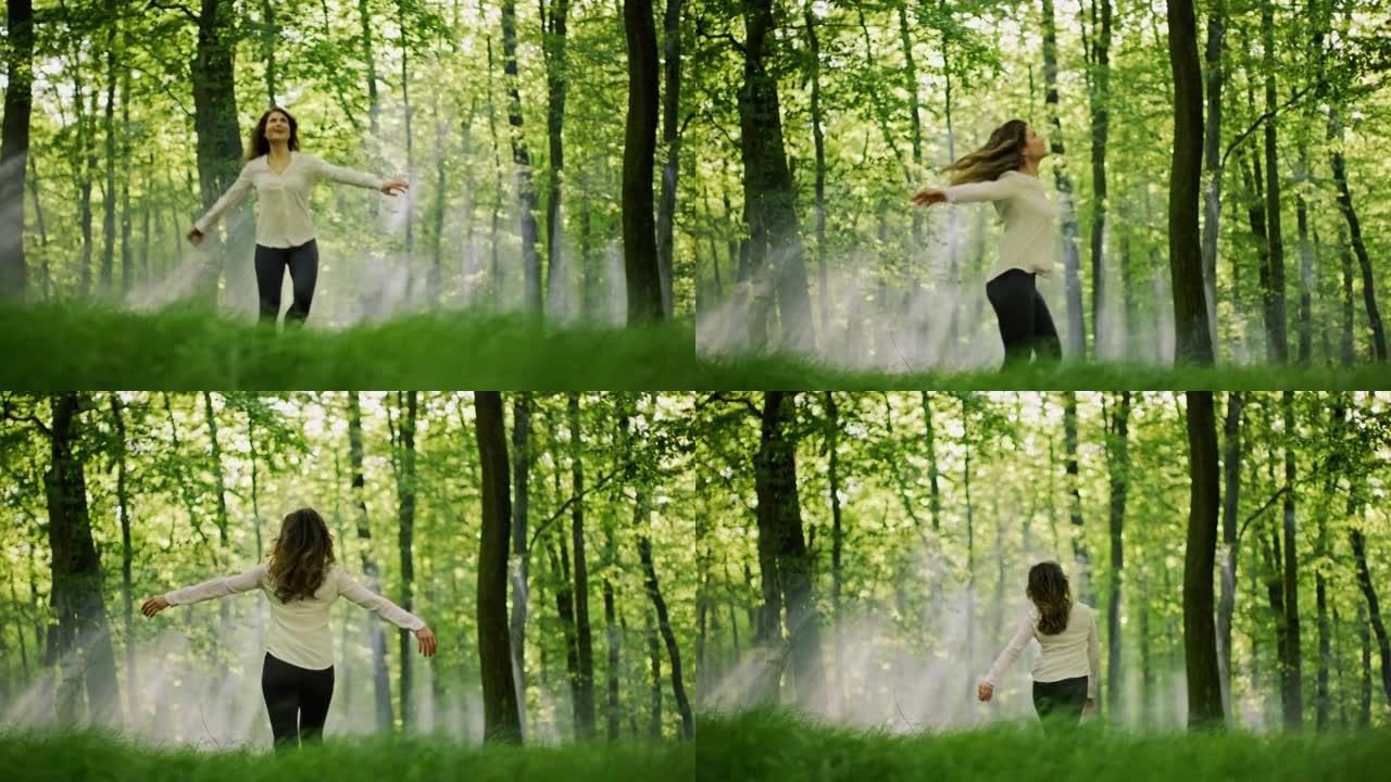 SLO MO女人在阳光明媚的森林中的绿色林间空地中旋转时享受着大自然