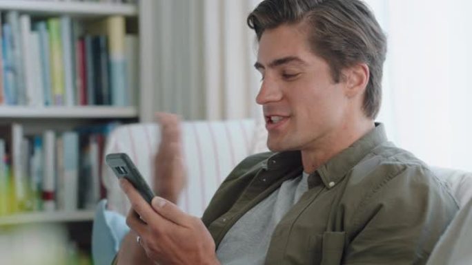 快乐的年轻人用智能手机视频聊天，与女朋友在线吹吻享受长途关系在家放松4k镜头