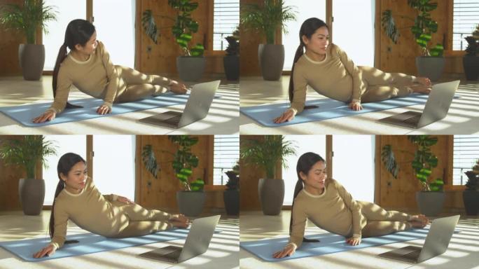 仍在拍摄: 亚洲妇女在搜索在线锻炼视频并开始锻炼