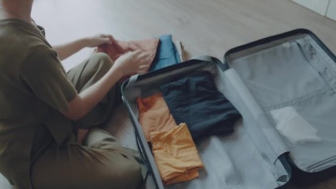 女人在假期回家打包行李箱。