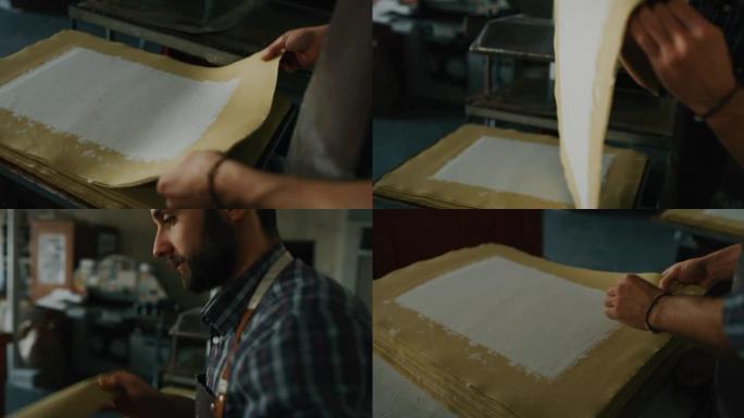 工匠造纸大师的慢动作正在车间里干燥高质量的手工纸。以8K拍摄。手工制作的概念，高品质，工匠，意大利制