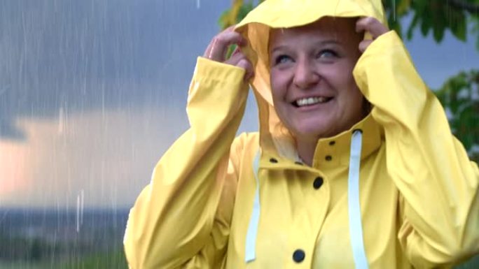 SLO MO雨滴落在一个穿着雨衣的女人身上