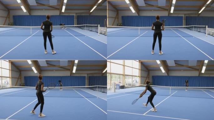 两名非洲女子在室内球场打网球