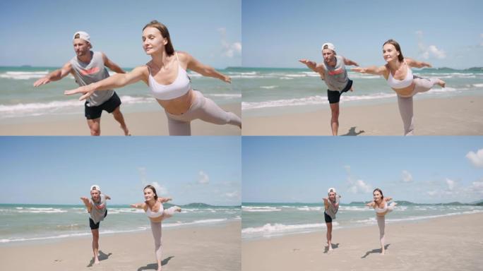 运动男女在沙滩上做瑜伽，慢动作