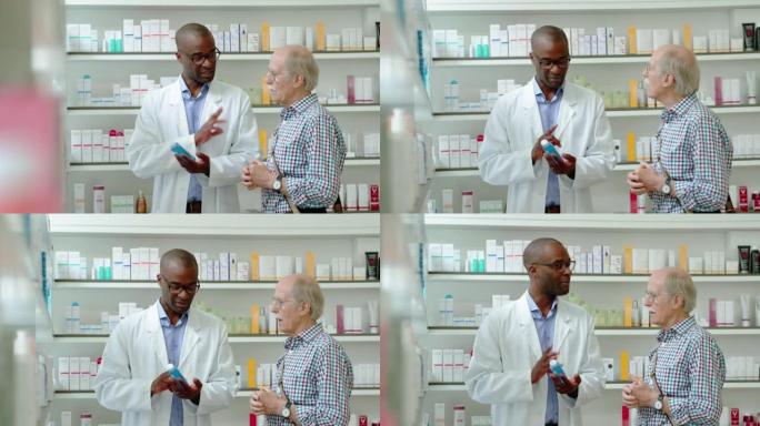 非洲男性药剂师在药店向男人展示药物时交谈