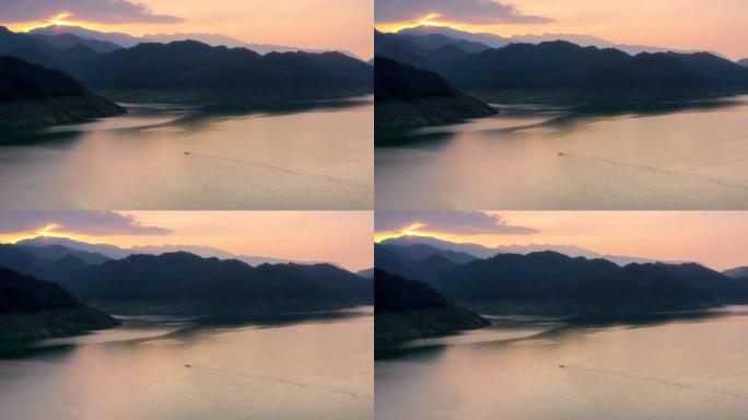 夕阳映照湖面，远处有山