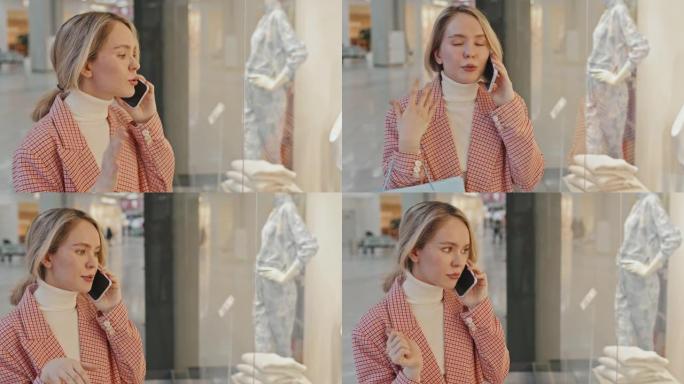 年轻漂亮的女人在买衣服时打电话