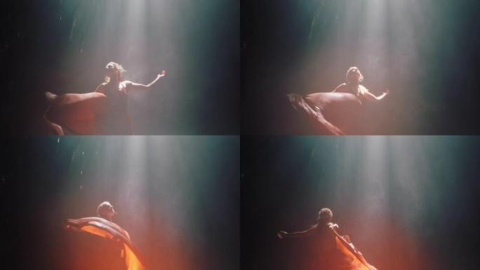 美丽的女人在瀑布洞里跳舞穿着漂亮的衣服享受舞蹈感受精神自由4k