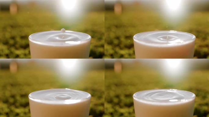 一滴牛奶掉进玻璃杯的超级SLO MO时间扭曲镜头