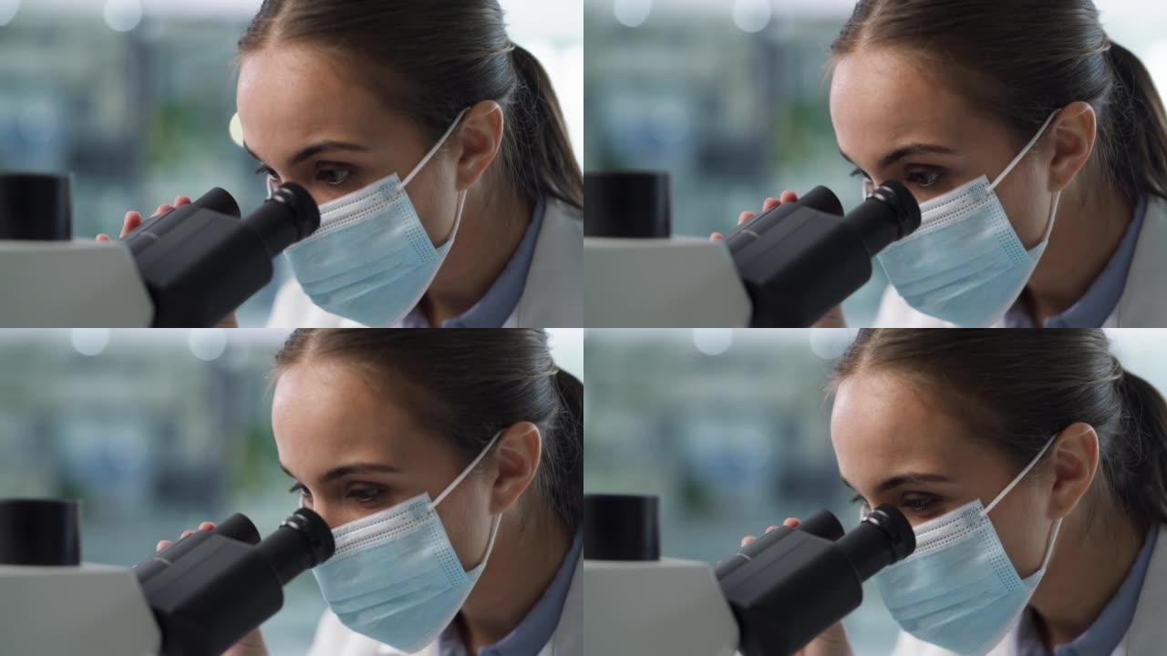 一名科学家在现代实验室使用显微镜的4k视频片段