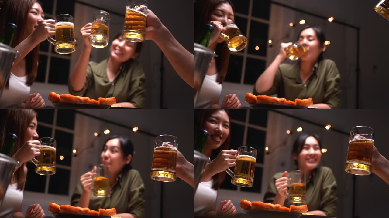 慢动作快乐的朋友在酒吧碰杯啤酒杯