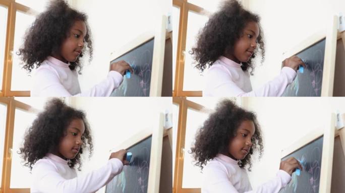 专注的小非洲卷发女孩孵化涂鸦
