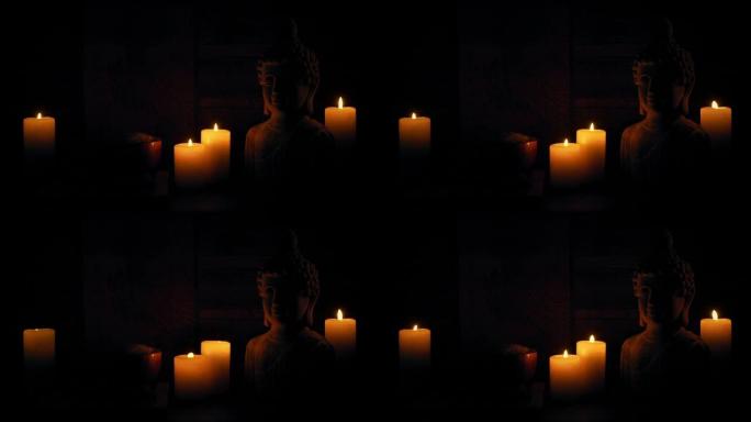 黑暗寺庙中的和平蜡烛和佛像