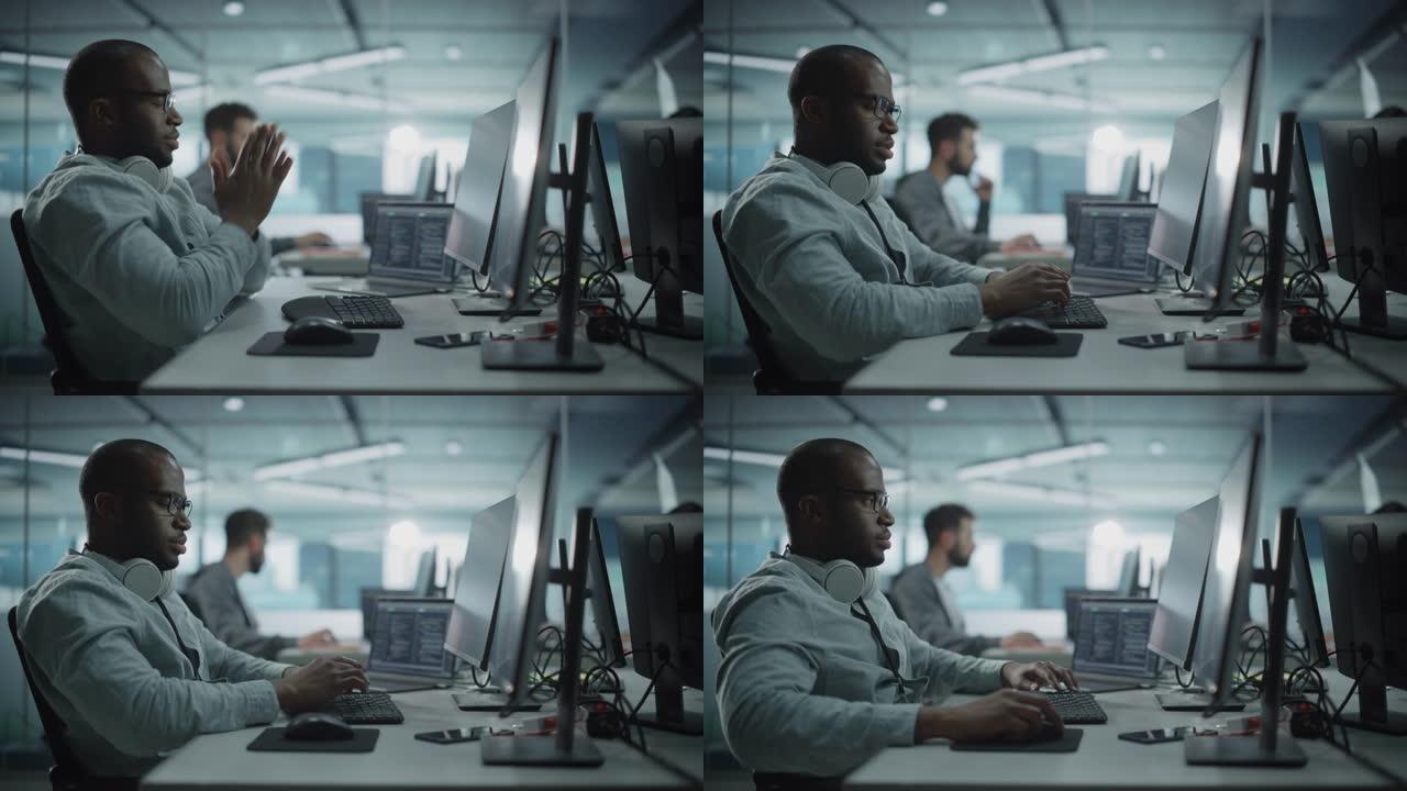真实的办公室: 在台式计算机上工作的黑色IT程序员的肖像。男性网站，软件工程师开发应用程序，程序，视
