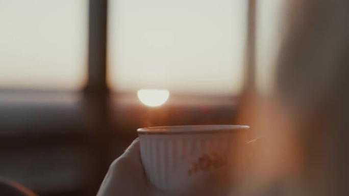 女人早上拿着喝茶光线喝咖啡热气腾腾